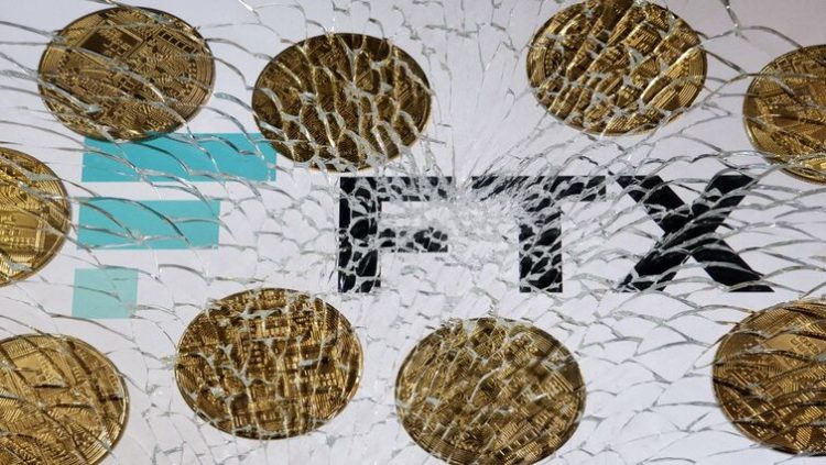 An FTX logo and a representation of cryptocurrencies are seen through broken glass in this illustration taken December 13, 2022.