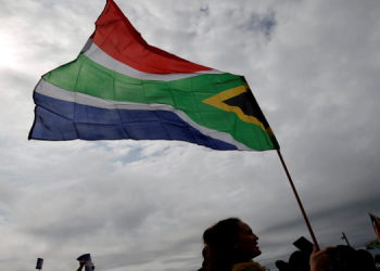 A person holds a SA flag during an event