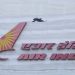 A bird flies over a logo of Air India airlines at the corporate headquarters in Mumbai, India, October 19, 2021.