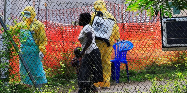 A woman and her child arrive for an ebola-related investigation at the health facility at the Bwera general hospital.