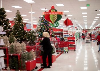 FILE PHOTO: Shoppers browse merchandise beside a Christmas tree display at a Target store.