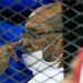 Sudan's ousted President Omar al-Bashir is seen inside the defendant's cage during his and some of his former allies trial over the 1989 military coup that brought the autocrat to power in 1989, at a courthouse in Khartoum, Sudan September 15, 2020. REUTERS/Mohamed Nureldin Abdallah/File Photo