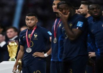 Soccer Football - FIFA World Cup Qatar 2022 - Final - Argentina v France - Lusail Stadium, Lusail, Qatar - December 18, 2022 France's Kylian Mbappe reacts after receiving the runners up medal and the Golden Boot award.