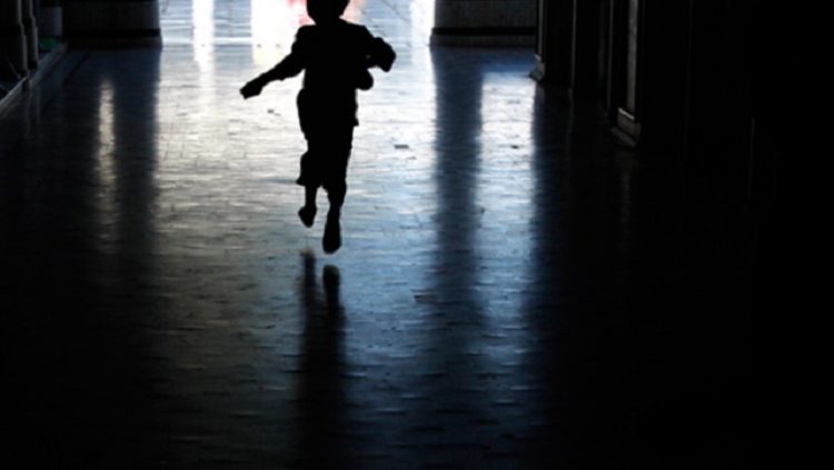 [File Photo]A child running from a dark room