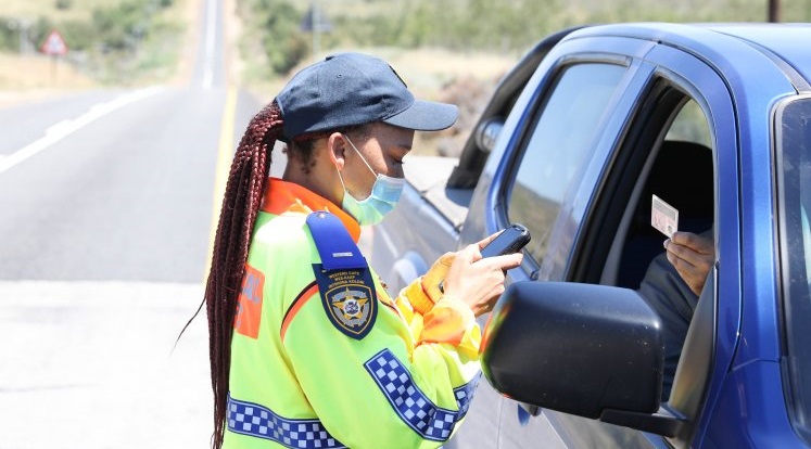 Traffic official checks a driver's licence in the Western Cape