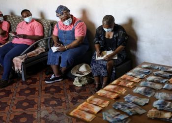 [File Photo] Bank notes are placed on the table after contributions from members of the Save Act Stockvel, during one of their gatherings in Vanderbilpark, in the south of Johannesburg, South Africa, September 11, 2021.