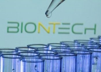 Test tubes are seen in front of a displayed Biontech logo in this illustration taken, May 21, 2021.