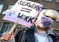 A protester holds a placard as Dutch sex workers demonstrate to demand the right to go back to work, amid the coronavirus disease (COVID-19) pandemic, in The Hague, Netherlands March 2, 2021.