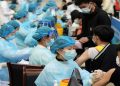 Medical workers inoculate students with the vaccine against the coronavirus disease (COVID-19) at a university in Qingdao, Shandong province, China March 30, 2021.