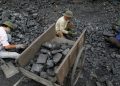 (File Image)Workers pick out gravel from coal at a coal port in Hanoi February 23, 2012.