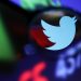 Twitter logo and stock graph are seen through a magnifier displayed in this illustration taken September 4, 2022. REUTERS/Dado Ruvic/Illustration