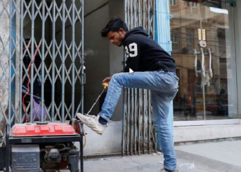 Man starts a generator outside his shop during a country-wide power breakdown in Karachi, Pakistan January 23, 2023