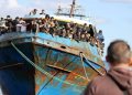 [File Image]; Migrants stand onboard a fishing boat at the port of Paleochora, following a rescue operation off the island of Crete, Greece, November 22, 2022.