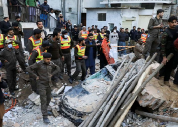 People and rescue workers gather amid the damages, after a suicide blast in a mosque in Peshawar, Pakistan January 30, 2023.