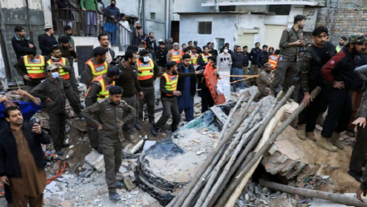 People and rescue workers gather amid the damages, after a suicide blast in a mosque in Peshawar, Pakistan January 30, 2023.
