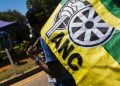 ANC supporter holds the party's flag