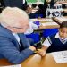 Western Cape Premier Alan Winde is pictured interacting with a pupil at the Starling Primary School in Cape Town on 18 January 2023.