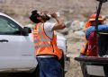 [File photo]A construction worker drinks water in temperatures that have reached well above triple digits in Palm Springs,.