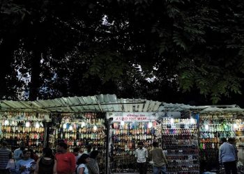 People shop for shoes at roadside shops at a market in Mumbai, India, August 30, 2016. Picture taken August 30, 2016.