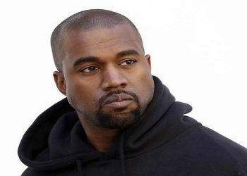 American rapper Kanye West poses before French fashion house Christian Dior Autumn/Winter 2015/2016 women's ready-to-wear collection show during Paris Fashion Week March 6, 2015.