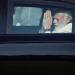 Indian Prime Minister Narendra Modi gestures as he leaves in a car after attending the funeral of his mother Heeraben, in Gandhinagar, India, December 30, 2022.