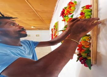 Nigerian artist Olufela Omokeko sets up an exhibition of fresh pepper motive at a gallery in Iwaya, Lagos, Nigeria January 30, 2021.