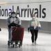 Passengers walk through the International arrivals area of Terminal 5 in London's Heathrow Airport, Britain, August 2, 2021.