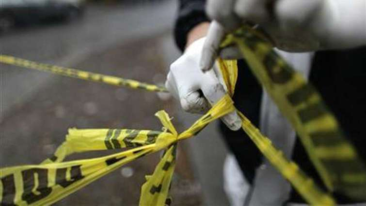 A police tape cordons off a crime scene.