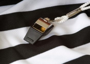 A referee's striped jersey and a whistle.