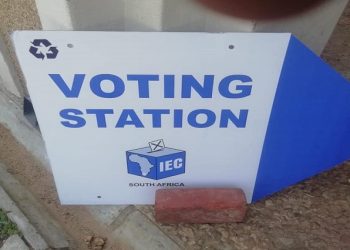 A board directing the public to a voting station.