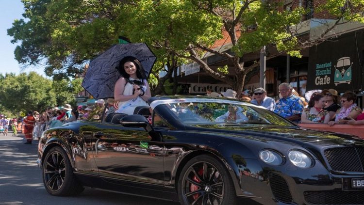 Winner of Parkes Elvis Festival Miss Priscilla 2023, Nickyra Burley, sits on top a car during the festival parade in Parkes, Australia, January 7, 2023.