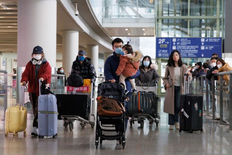 Passengers push their luggage through the international arrivals hall at Beijing Capital International Airport after China lifted the coronavirus disease (COVID-19) quarantine requirement for inbound travellers in Beijing, China January 8, 2023.