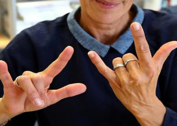 [File photo] A teacher of sign language says "I love you" with her hands.