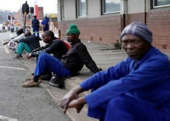 Unemployed men wait on a street corner in the hope of getting casual work.
