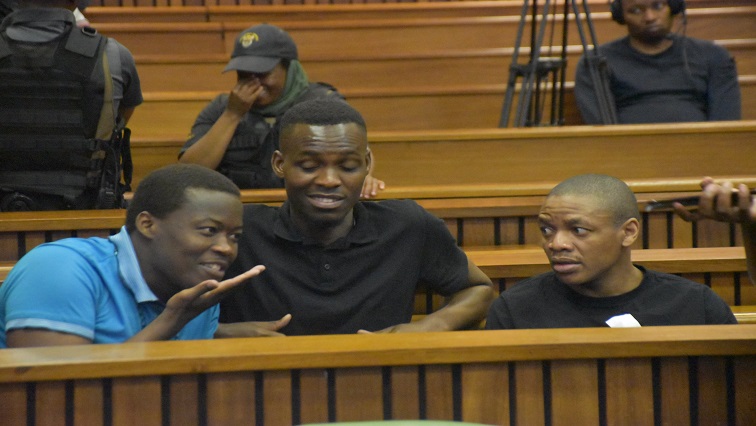 Accused 1, Muzi Sibiya (blue shirt) speaking to accused 2, Bongani Ntanzi and Mthobizi Mncube during the Senzo Meyiwa murder trial at the high court in Pretoria.