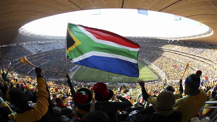 Fans hold up a South African flag before the 2010 World Cup opening match between South Africa and Mexico at Soccer City stadium in Johannesburg June 11, 2010.