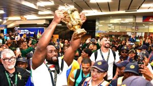 The Springboks Captain Siyamthanda Kolisi lift up the trophy with Eben Etzebeth in the background.