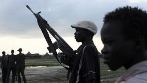 A youngster holds a rifle in South Sudan