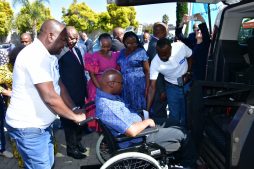 President Ramaphosa stands next to a person in a wheelchair at the Transport Summit