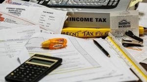 File image: A desk with an income tax text book and stationary.
