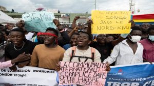 People in Democratic Republic of Congo react during a funeral of 9 victims